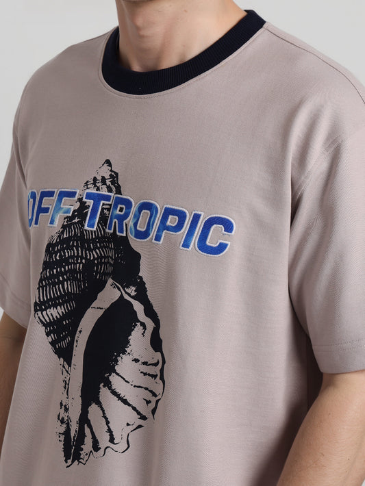 T-shirt with 'OFF TROPIC' design on a plain background
