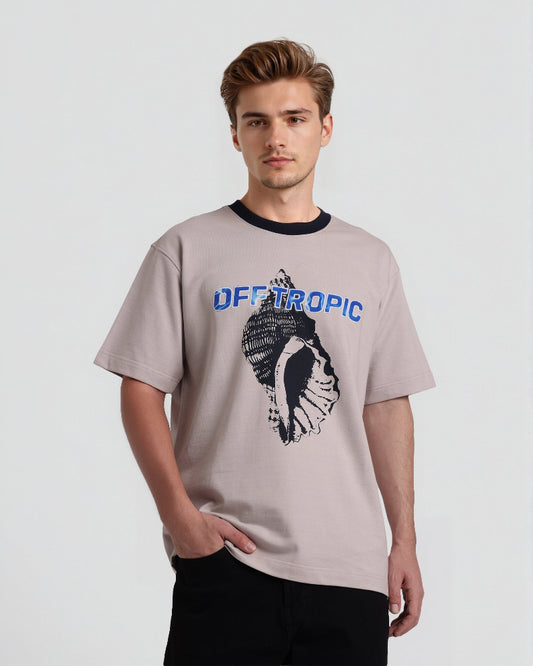 Man wearing a beige t-shirt with 'OFFTROPIC' design on a light gray background